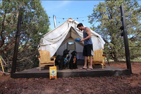 Jordan and his two dogs, Zeus and Sedona, at camp